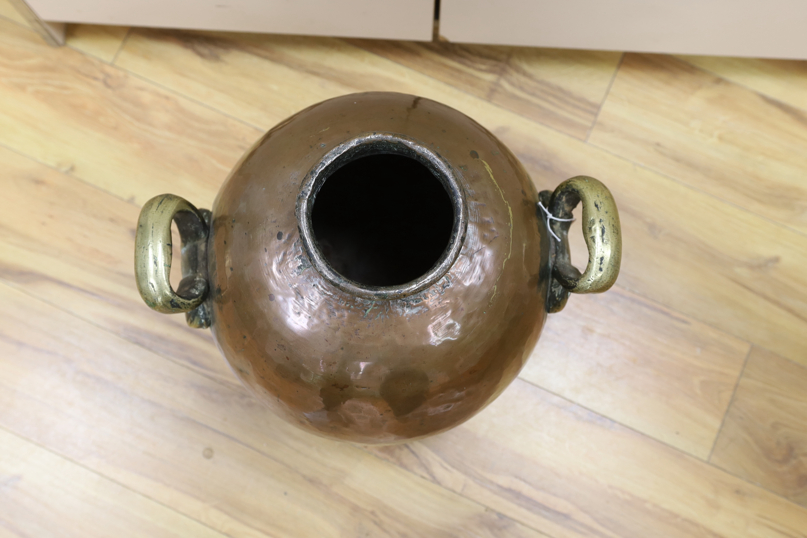 A large 19th century Egyptian copper olive jar with twin handles, 42cm high